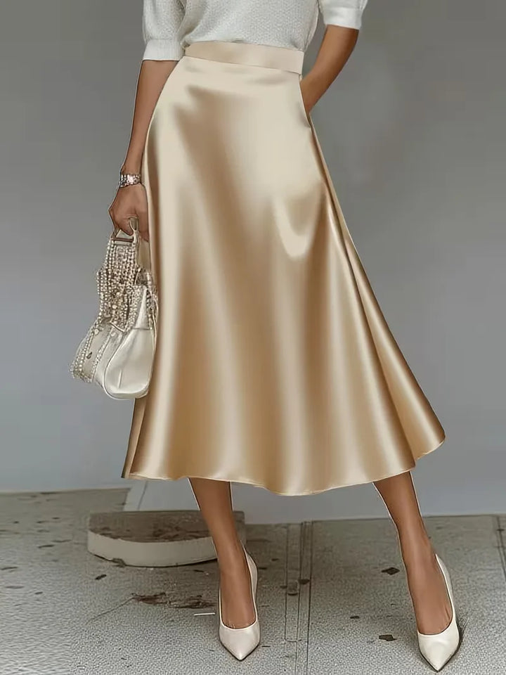 Hoogwaardige satijnen midirok in goudtint, hoge taille. Voegt elegantie toe aan elke damesgarderobe.