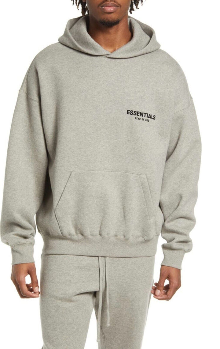 "Essentials oversized unisex hoodie in beige, grijs of zwart met ruime capuchon, buidelzak en minimalistisch ontwerp."