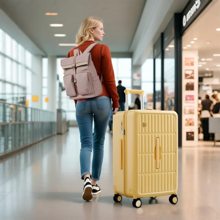 Gele harde koffer met 8 soepele spinnerwielen, ideaal voor ruim inpakken op vakantie.