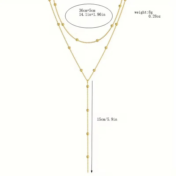 Chique damesketting in goudkleur met natuurlijke rijstparels en sierlijke franjes. Een trendy accessoire.