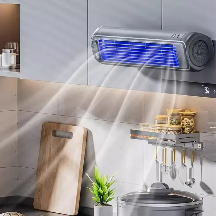 Grijze AirWave compacte airconditioner naast een laptop. Krachtige koeling voor kantoor en thuis.