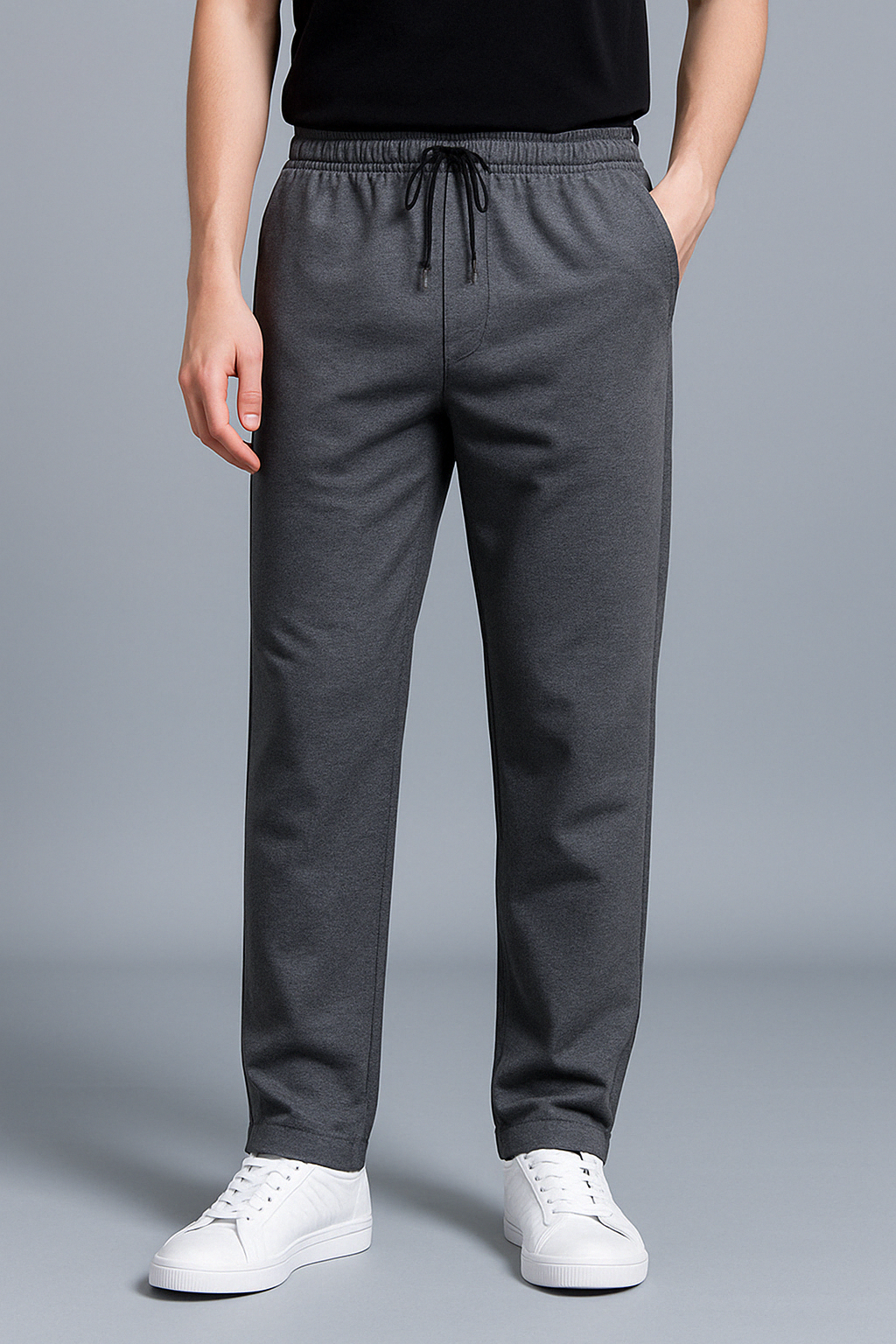 Zwarte polyester heren joggingbroek, detail van elastische tailleband met trekkoord, comfort en stijl