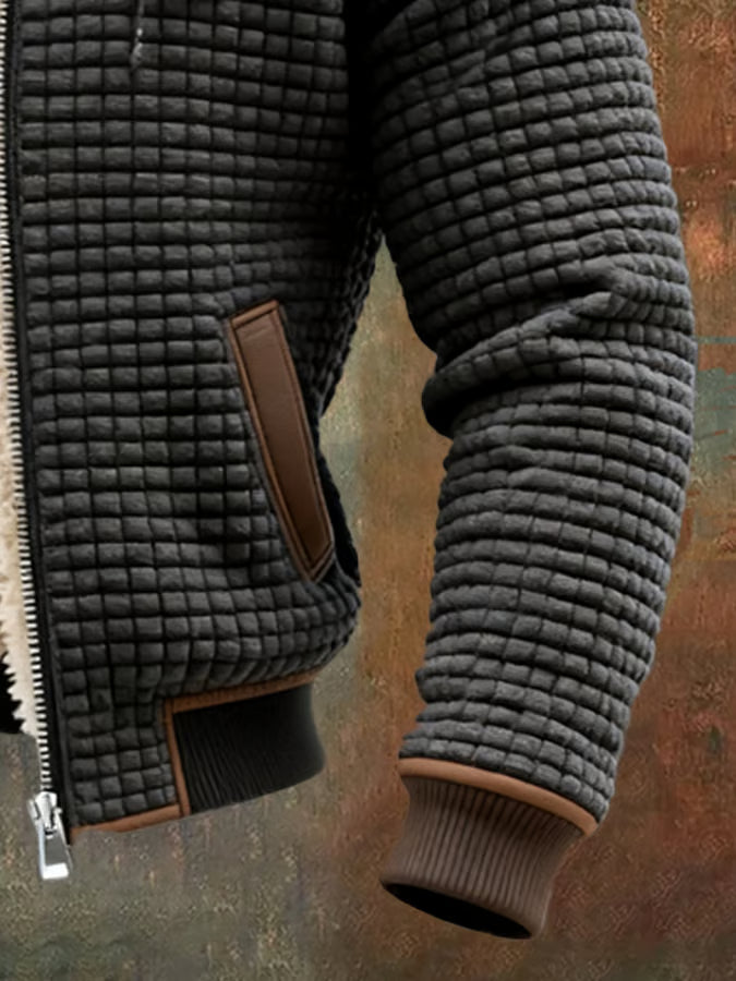 Heren winterjack met wafeltextuur, warme voering, capuchon en ritssluiting. Geschikt voor outdoor en casual.