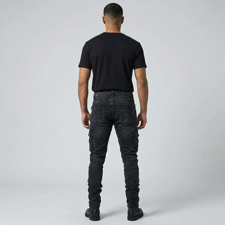Model draagt casual heren stretch jeans, middenblauw, staand voor een stedelijke achtergrond, focus op comfort.