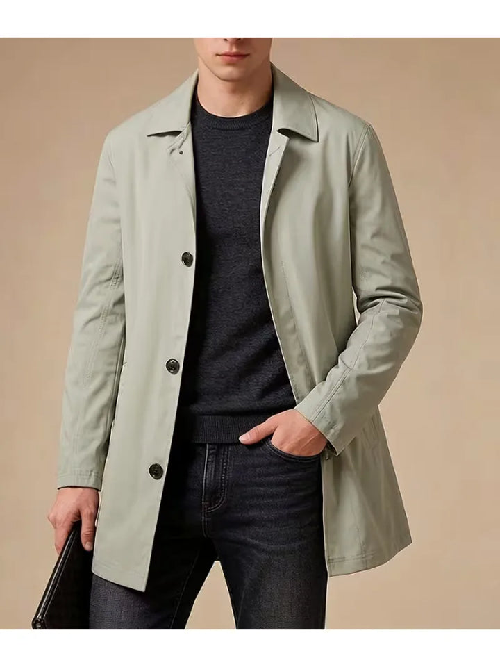 Deze slim fit heren trenchcoat combineert functionaliteit met elegantie door verfijnde zakken.