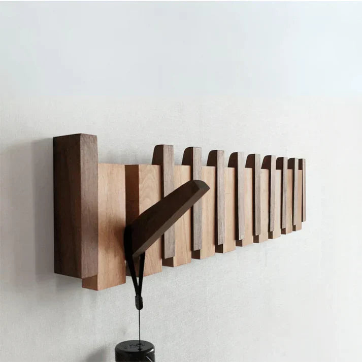Detailopname van piano kapstok haken, gemaakt van licht hout, functioneel wandrek voor garderobe.