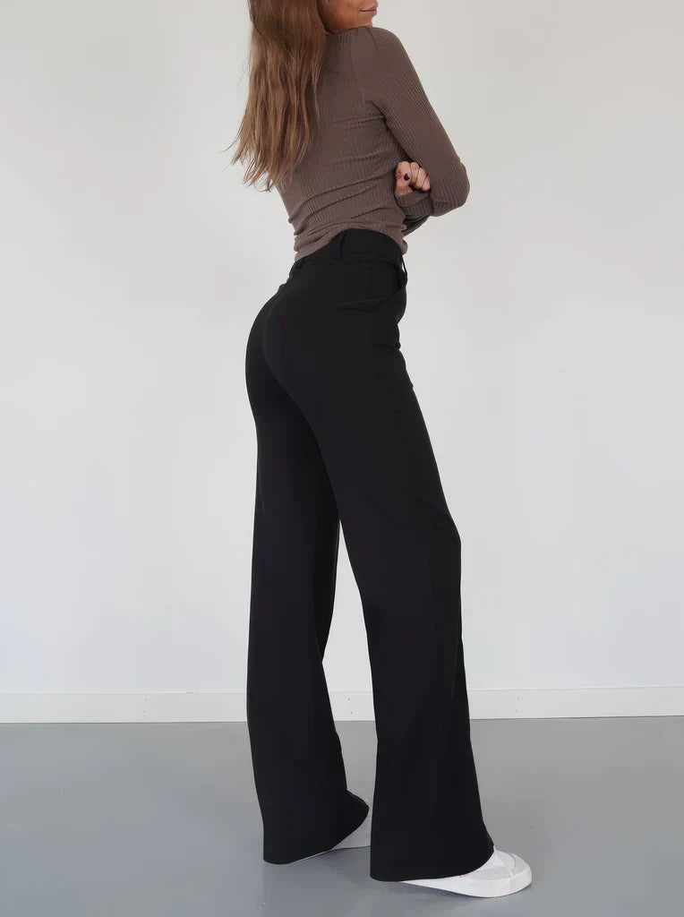 Donkere Hoymans pantalon voor dames, slim fit met wijde pijpen, ideaal voor zakelijk of avondkleding.