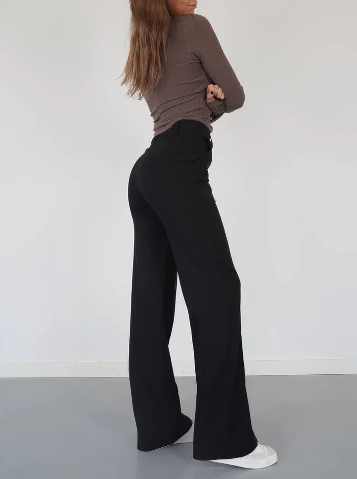 Donkere Hoymans pantalon voor dames, slim fit met wijde pijpen, ideaal voor zakelijk of avondkleding.