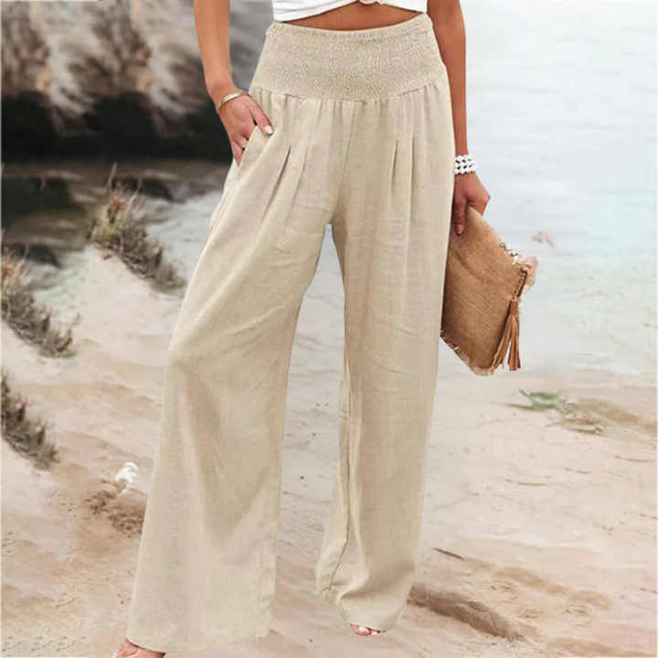 "Khaki damesbroek met wijde pijpen en praktische zakken, biedt stijl en comfort voor verschillende gelegenheden."