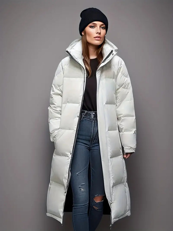 Dames lange pufferjas parka met capuchon, stijlvol en functioneel voor koude winterdagen.
