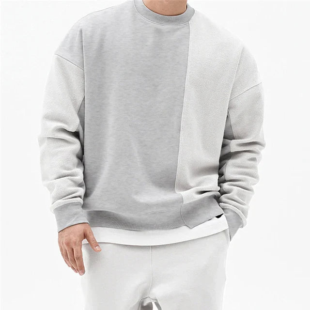Stijlvolle heren sweater met opvallende asymmetrische naad en ronde hals, een moderne must-have voor wintermode.