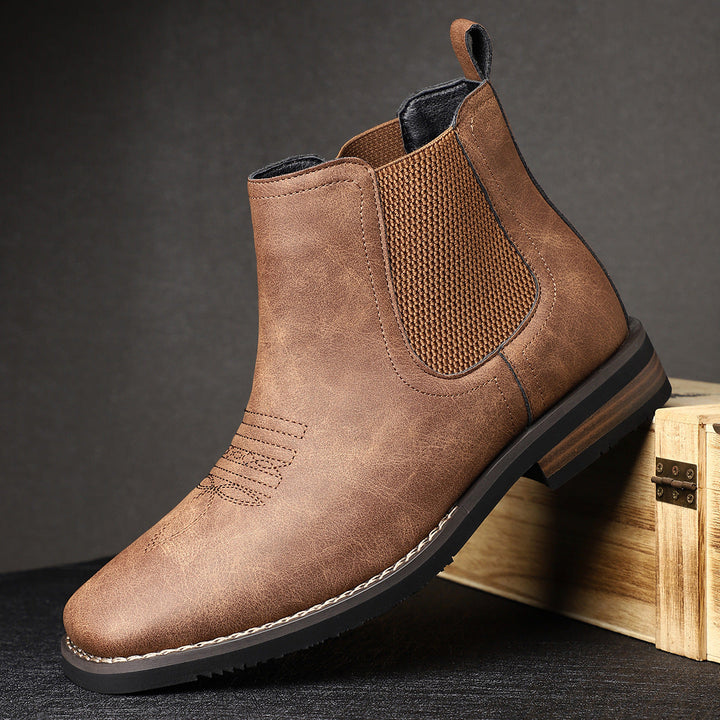Modieuze heren Chelsea boots met western stiksels; zwarte instaplaarzen voor comfort en stijlvolle casual outfits.