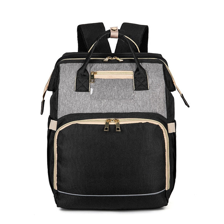 Moderne babyrugzak met multivakken; transformeerbaar tot comfortabel babybedje voor onderweg.