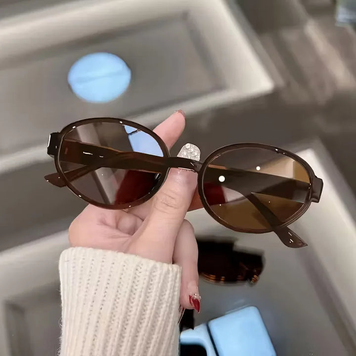 Stijlvolle zwarte ovale zonnebril voor dames en heren, een elegante en lichtgewicht accessoire.