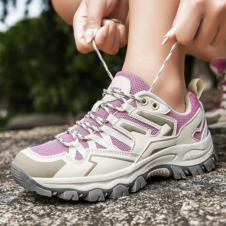 Paarse dames wandelschoenen met roze accenten, stevige gripzool en comfortabele ondersteuning voor alle terreinen.