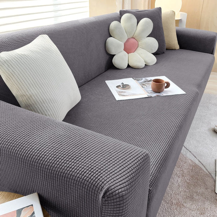 "Rekbare bankhoes met strakke pasvorm, elastisch materiaal in stijlvol design, beschermt tegen vlekken en huisdierharen."