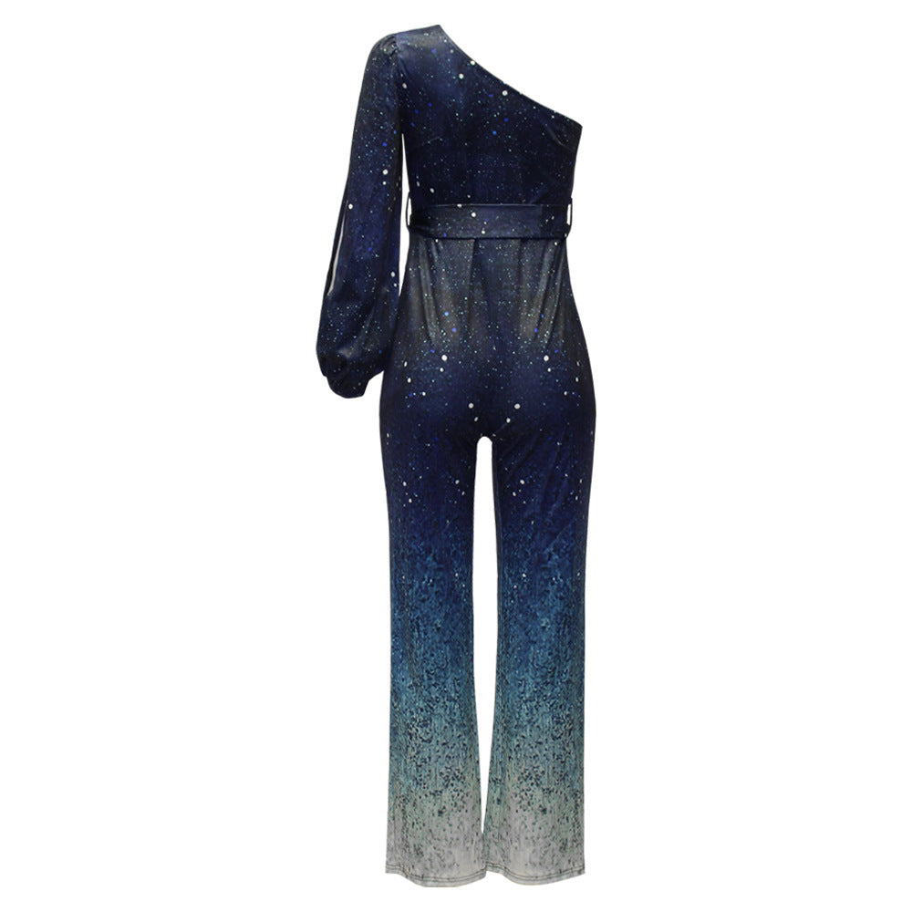 Retro blauwe one shoulder jumpsuit met ombre wijde pijpen en opvallende 70s glamour, ideaal voor feestjes en evenementen.
