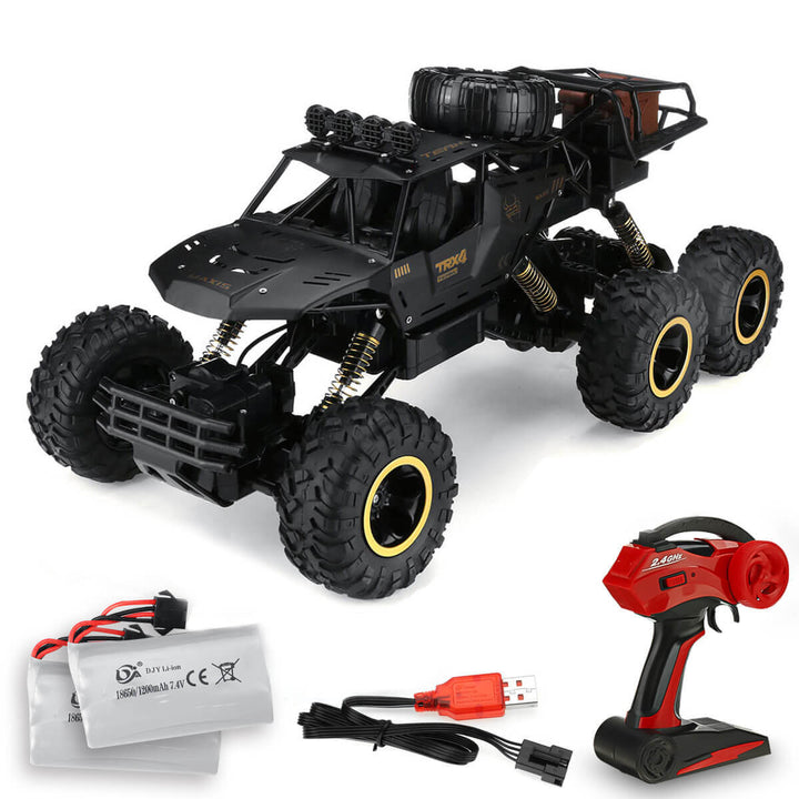 Bovenafzicht van de 6-wiel RC monster truck. Toont chassis, 2.4GHz systeem en schaal 1:12.