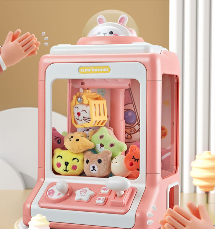 "Roze Mini Claw Machine speelgoed met licht- en geluidseffecten voor kinderen, ontwikkelt fijne motorische vaardigheden."