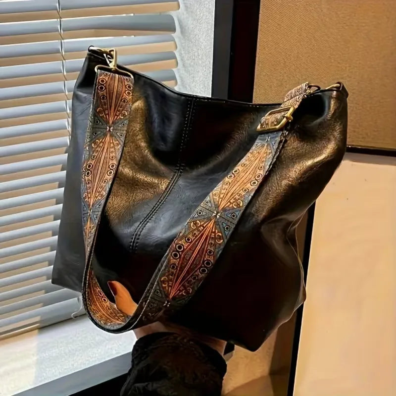 Schoudertas voor dames met kleurrijke band, ritssluiting en ruime inhoud. Stijlvol en praktisch voor dagelijks gebruik.