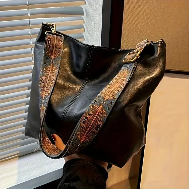 Schoudertas voor dames met kleurrijke band, ritssluiting en ruime inhoud. Stijlvol en praktisch voor dagelijks gebruik.