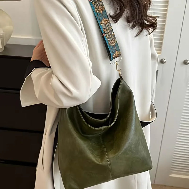 Stijlvolle dames schoudertas met levendige kleurrijke strap. Een modieuze en functionele tas voor elke gelegenheid.
