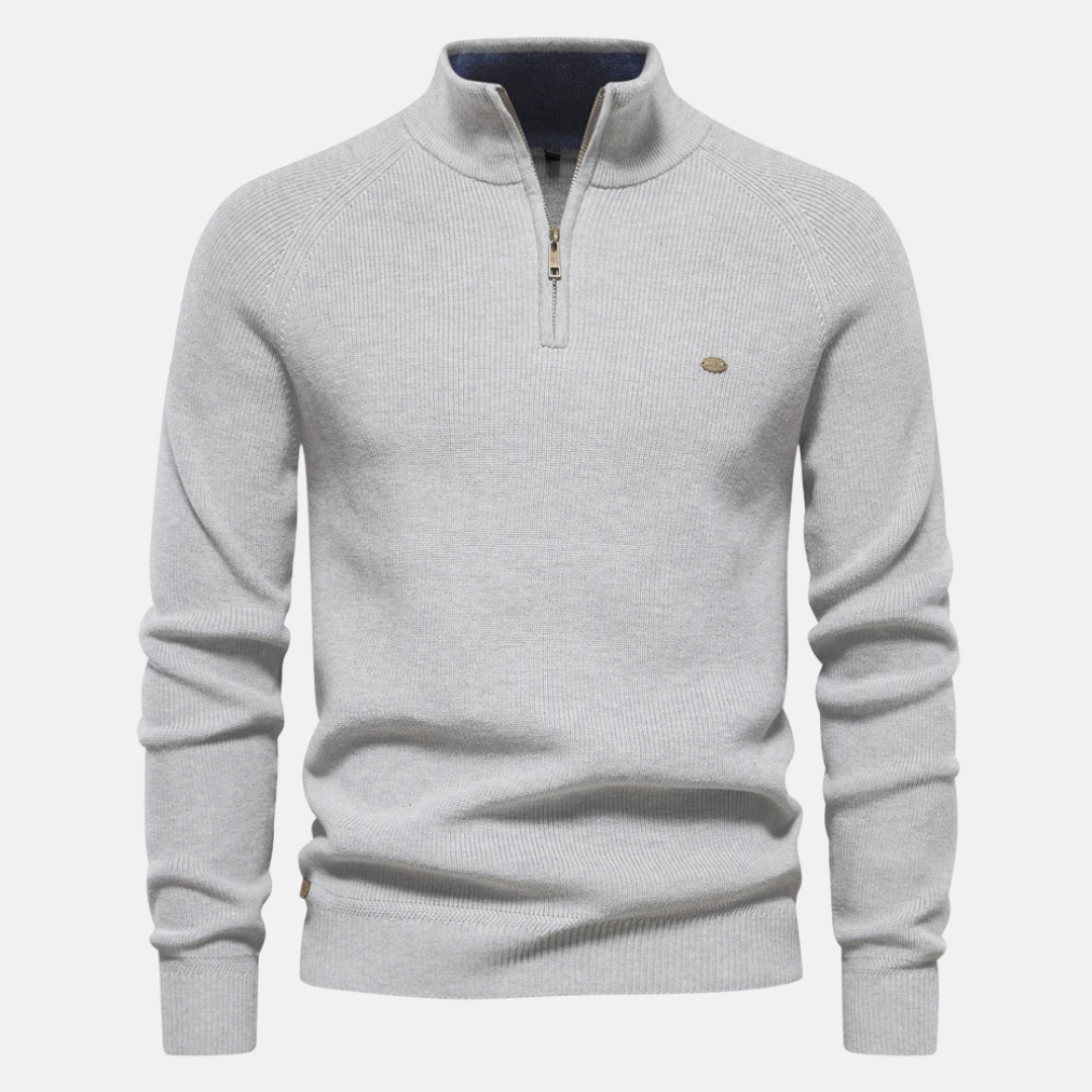 Modieuze heren half-zip trui met ribgebreide mouwen, combineert warmte en stijl voor de moderne man.