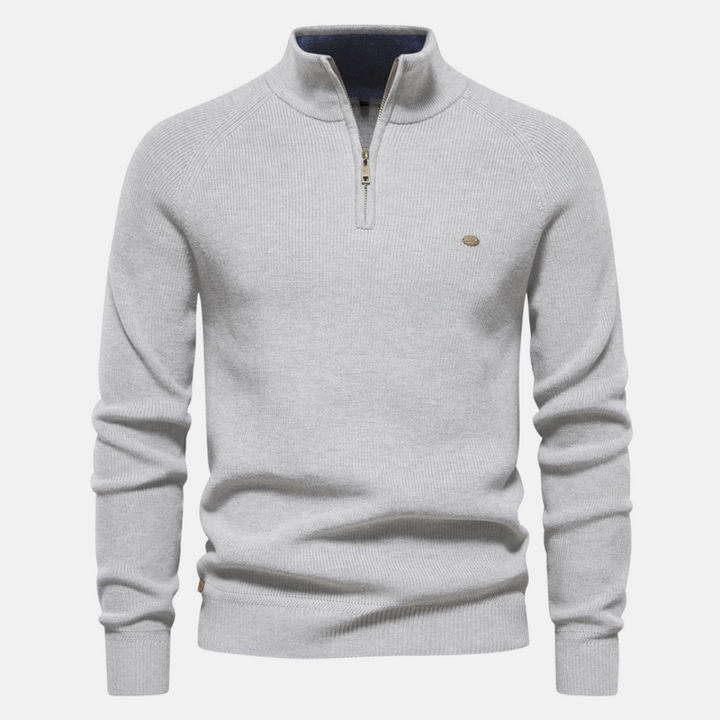 Modieuze heren half-zip trui met ribgebreide mouwen, combineert warmte en stijl voor de moderne man.