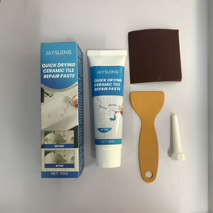 Tegelreparatiepasta OneStop, witte tube met beschadigde tegel in achtergrond, voor keramiek, porselein, marmer.