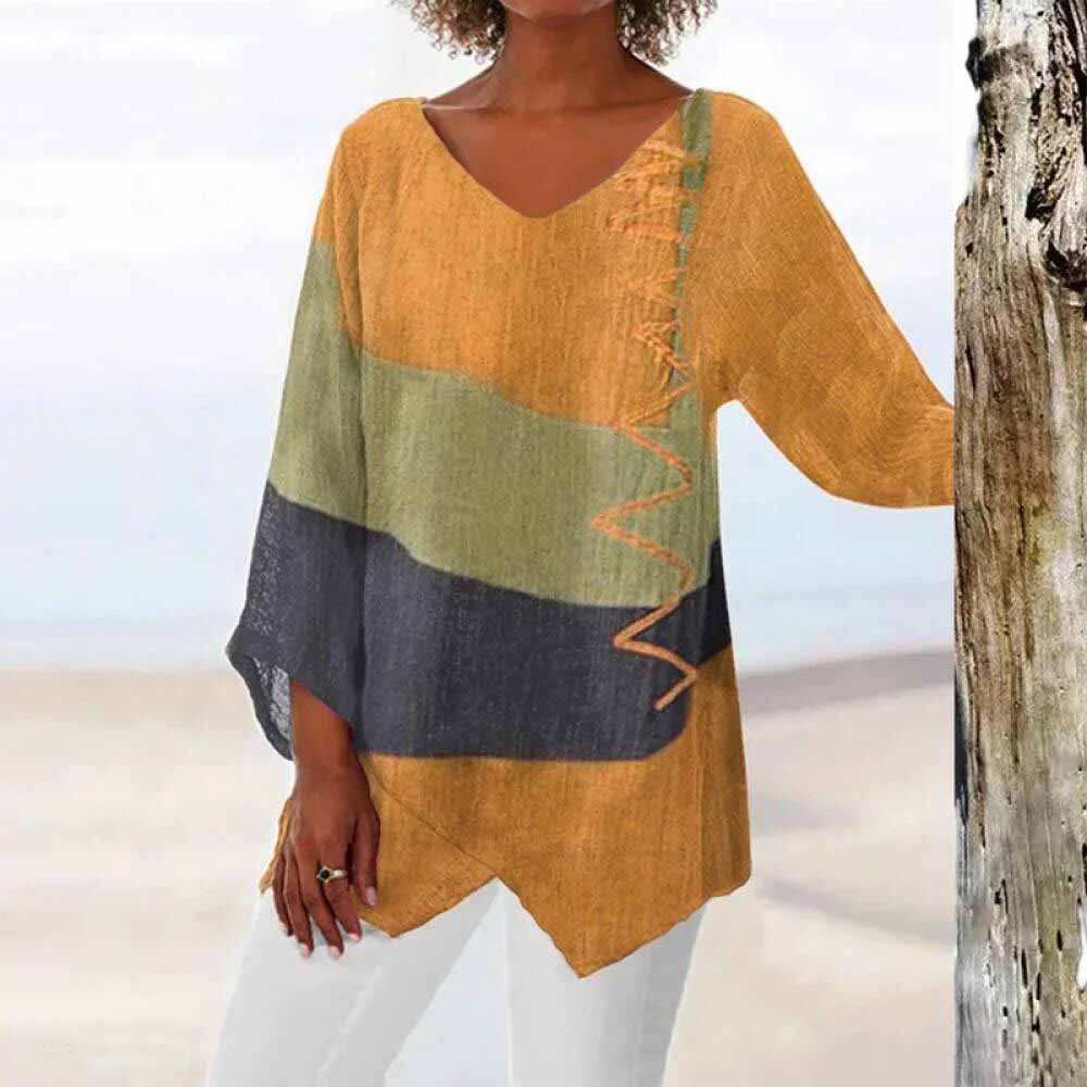 Oversized dames blouse met asymmetrisch kleurblok, V-hals en driekwart mouw. Comfortabel en vrouwelijk.