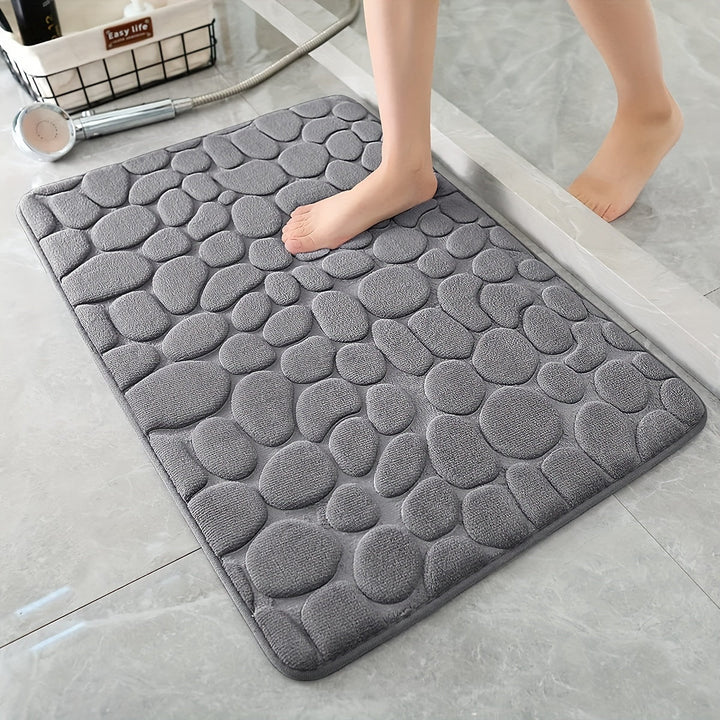 Antislip badmat met getextureerd oppervlak in grijze badkamer, ideaal voor veiligheid.