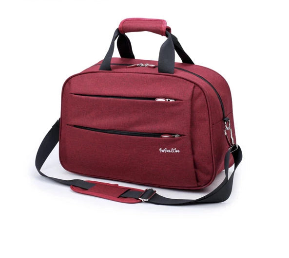 Zwarte handbagage reistas voor dames en heren, met extra trolleyband.