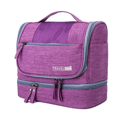 Compacte reistoilettas met haak, multi-compartment voor georganiseerd opbergen op vakantie.