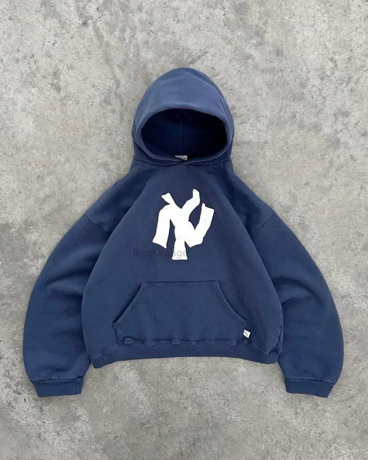 Model draagt comfortabele unisex Y2K oversized hoodie met levendige abstracte kunst, perfect voor een casual look.