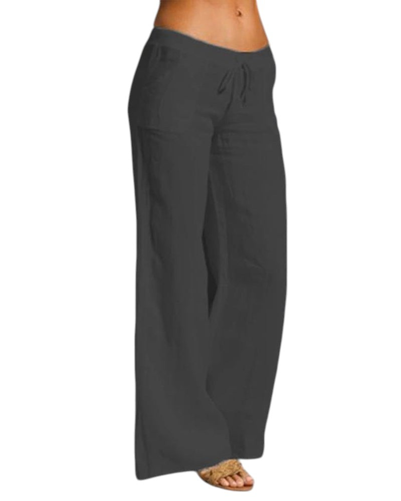 Vrouw draagt elegante, luchtige linnen broek met elastische taille in zwart. Perfect voor casual en formele gelegenheden.