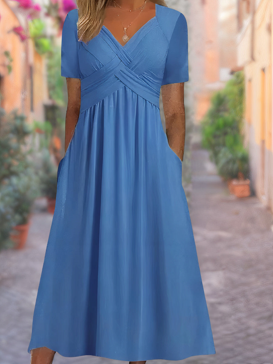 Damesjurk met v-hals en zwierige zoom, elegant en comfortabel voor zomerdagen.