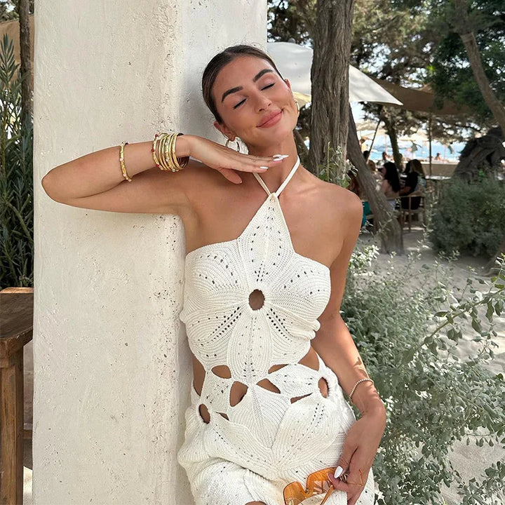 Witte gehaakte tweedelige dames set bestaande uit een chique haltertop en bijpassende mini-rok voor de zomer.