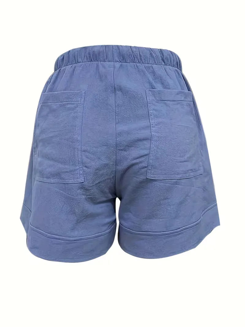 Koraalkleurige dameshorts, relaxte pasvorm, trekkoord. Ideaal voor een veelzijdige zomerlook.