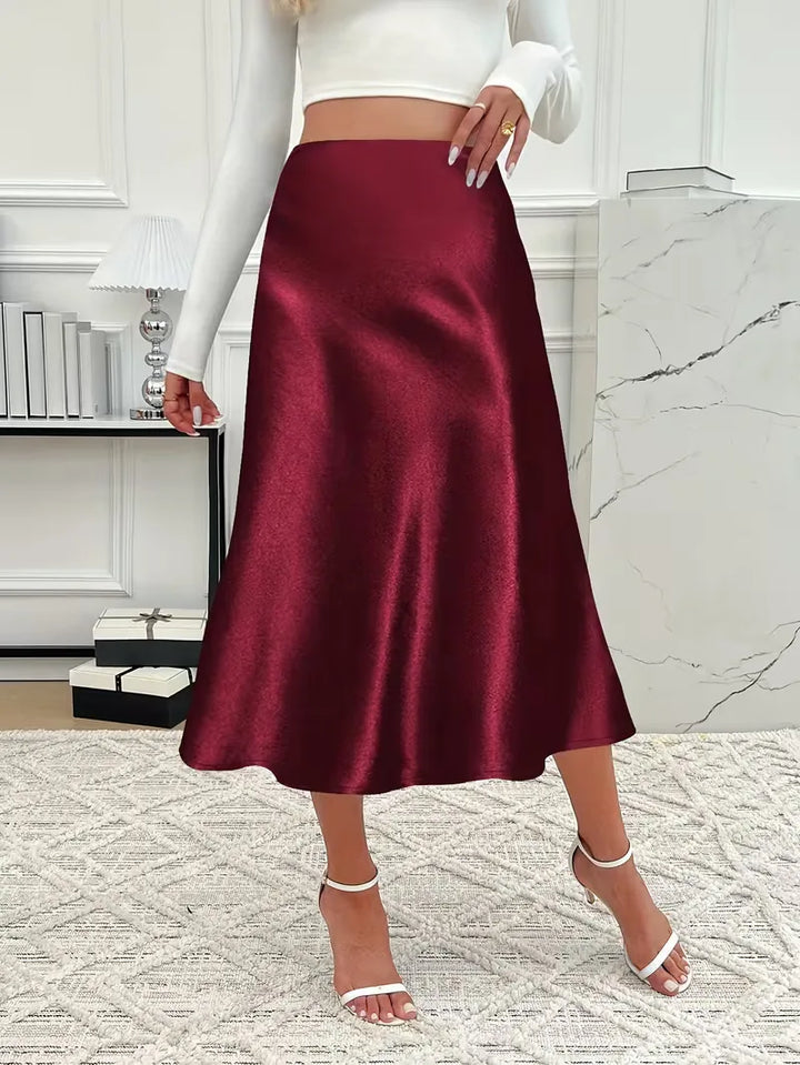 Grijze satijnen damesrok, hoge taille, zakelijk chique of casual elegant.